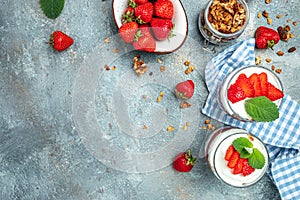 Parfait with yogurt, granola, jam, fresh berries and mint leaves in glass jar. gluten free diet, Healthy breakfast. banner, menu,