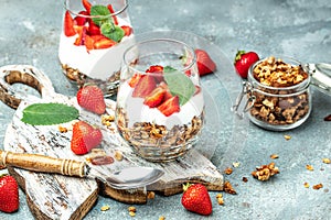 Parfait with yogurt, granola, jam, fresh berries and mint leaves in glass jar. gluten free diet, Healthy breakfast. banner, menu,