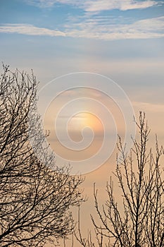 A parhelion (plural parhelia, sundog) - atmospheric optical phenomenon that consists of a bright colored spot in the sky