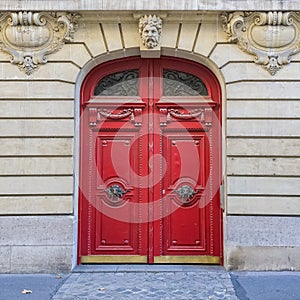 Paris, an ancient wooden door, beautiful facade