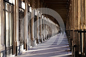 Paris arches Palais royal gardens arcade at sunset