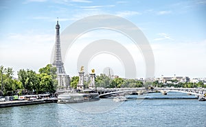 Paris, boats and barges with view on the Eiffel Tower and the Bridge Alexandre III, between the quai d`orsay and the Grand Palais