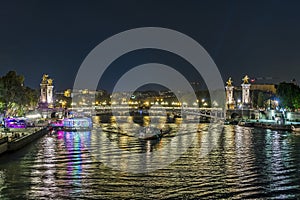 Paris Center at Night with Boats Traffic Over Seine River Bridges and Docks