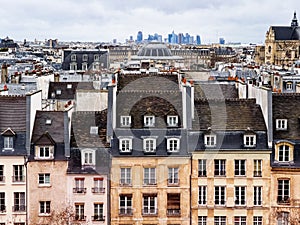 Paris city old buildings and roofs with La Defense