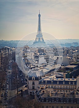 Paris cityscape with view to the Eiffel Tower, France. Beautiful parisian architecture with historic buildings, landmarks and busy