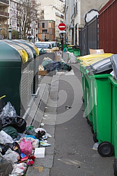 Paris dirty sidewalks loaded with recycling containers and garbage bins