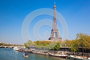 Paris with Eiffel Tower against boats during spring time in France