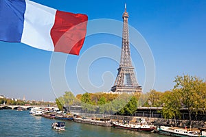 Paris with Eiffel Tower against french flag during spring time in France