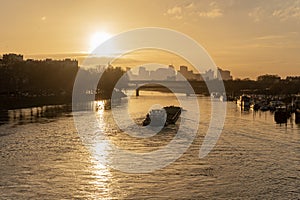 Paris, France - 01 30 2022: Quays of the Seine. View of the freight of a barge sailing along the Seine and The Defense district at