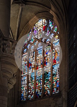 Beautiful stained glass window inside Notre Dame de Paris.