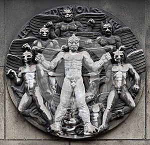 The seven demons. Stone relief at the building of the Faculte de Medicine Paris. photo