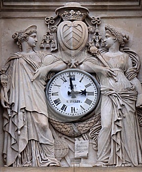 Two muses support the clock, topped by the coat of arms of Cardinal Richelieu, Saint Ursule chapel of the Sorbonne in Paris photo