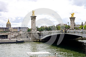 PARIS, FRANCE - JUNE 6, 2022: Detail of Pont Alexandre III Bridge with Les Invalides complex buildings on the background