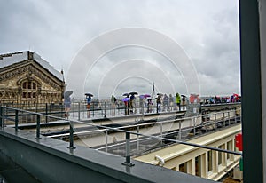 Paris, France, June 2022. The panoramic terrace of Galeries Lafayette on a rainy day: tourists do not give up enjoying the