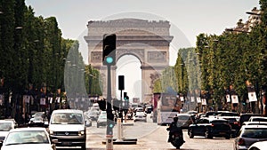 PARIS, FRANCE - JUNE 11, 2023. Road traffic jam on Avenue des Champs-Elysees and distant Arc de Triomphe de l'Etoile