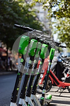 Paris, FRANCE - June 27, 2019: View of Lime electric scooters, rented through a mobile app and dropped off anywhere in the French