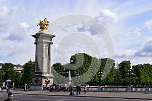 Paris, France - May 1, 2018: The Pont Alexandre III bridge across the Seine River and Petit Palais on the riverside, in front of