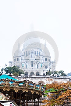 Paris, France, 11.22.2018 Montmartre, View of the Sacre Coeur Basilica and the top of the carousel on a fall day