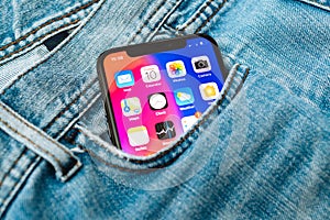 New Apple iPhone X 10 in pocket of denim jeans trousers