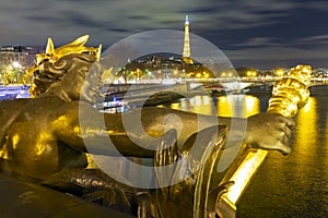 Paris, France - Nov, 28 - 2021: Statue at the Alexander III Bridge with the Eiffel Tower in the background, Paris, France