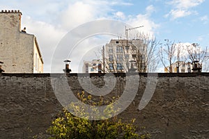 Paris, France - November 3rd 2019: Urban landscape behind a wall - square Henri-Karcher