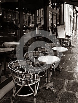 Paris, France, Parisian cafe, tables and chairs on paved sidewalk, black and white photo