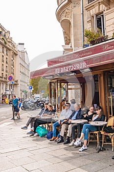 Paris France people drinking coffee on the terrace of a cafe restaurant during the Autumn