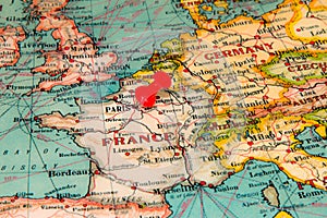 Paris, France pinned on vintage map of Europe