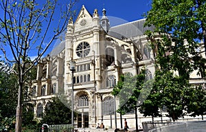 Paris, France, Saint Eustache church, Les Halles. Gothic facade and park. Sunny day, blue sky.