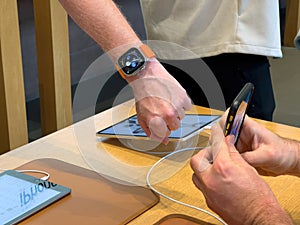 Apple Store first day of sale for new titanium Apple Watch Ultra on male hand -