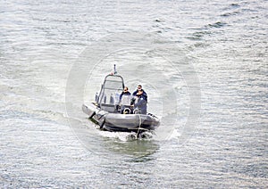 police boat on the Seine river with three officers