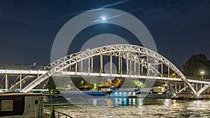 Paris, France - Timelapse - Full Moonrise over Bridge in Paris Touristic Center Seine River and Cruises