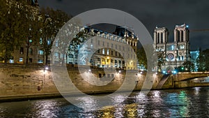 Paris, France - Timelapse - Paris Touristic Scenery at Night Notre-Dame Cathedral Seine River Reflections Clouds