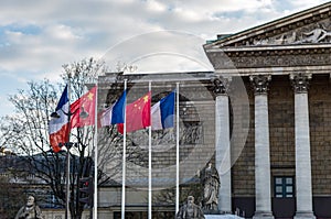 Paris: French and Chinese flags in the wind in front of National