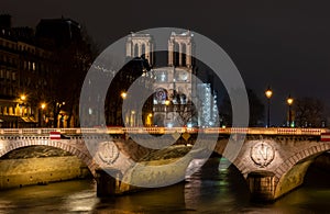 Paris at night, Changer bridge against the backdrop of Not-ter-Dame de Paris, illuminated by lights