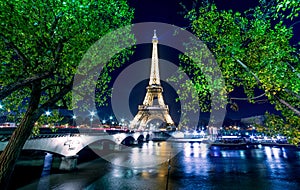 Paris night cityscape. Eiffel tower light show on Seine river