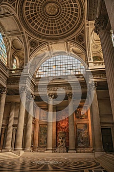 Pantheon inside view with high ceiling, columns, statues and paintings richly decorated in Paris.