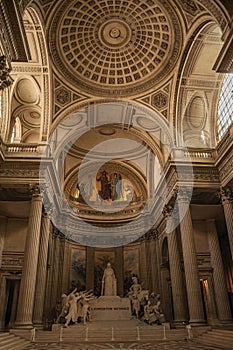 Pantheon inside view with high ceiling, columns, statues and paintings richly decorated in Paris.