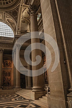 Pantheon inside view with high ceiling, columns, statues and paintings richly decorated in Paris.