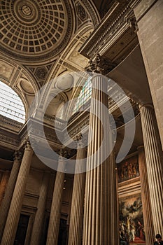 Pantheon inside view with high ceiling, columns, statues and paintings richly decorated in Paris.