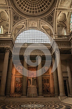 Pantheon inside view with high ceiling, columns, statues and paintings richly decorated in Paris.