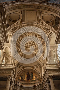 Pantheon inside view with high ceiling, columns, statues and paintings richly decorated in Paris.