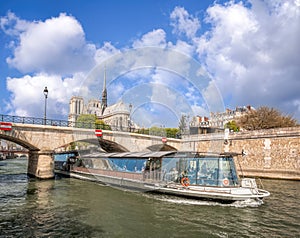 Paris, Notre Dame cathedral with boat on Seine in France