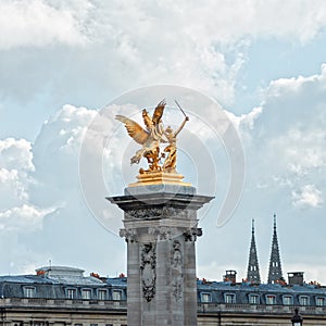 Paris, Pont Alexandre III, the Pegasus on a background cloudy sk
