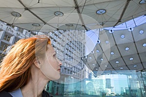 Paris, portrait of woman under Arch de la Defens