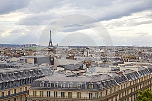 Paris rooftops view and Eiffel Tower in a cloudy day in France