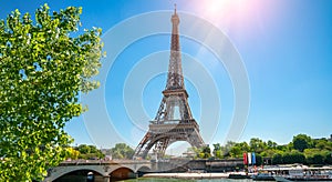 Paris street with view on the famous paris eiffel tower on a sunny day with some sunshine