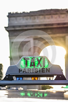 Paris taxi detail and Arc de Triomphe in the background