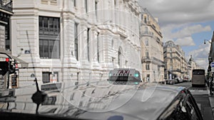 Paris taxi. Lights green, taxi free. Against the background of a blurred urban landscape. Close-up. Slow Motion