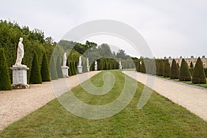 Part of beautiful garden of Versailles palace with statues and f